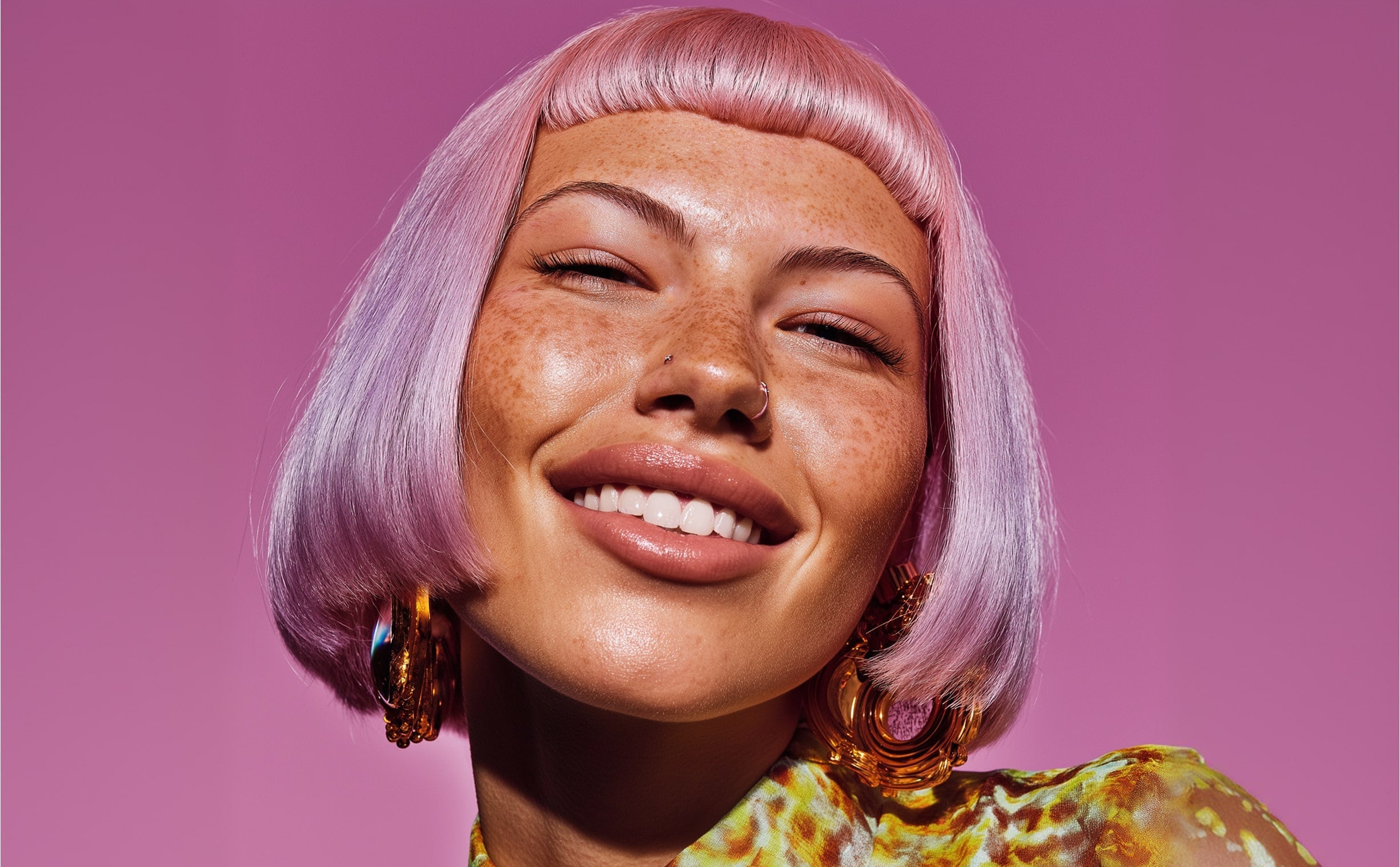 Smiling woman with pastel pink bob haircut and colorful outfit against pink studio background