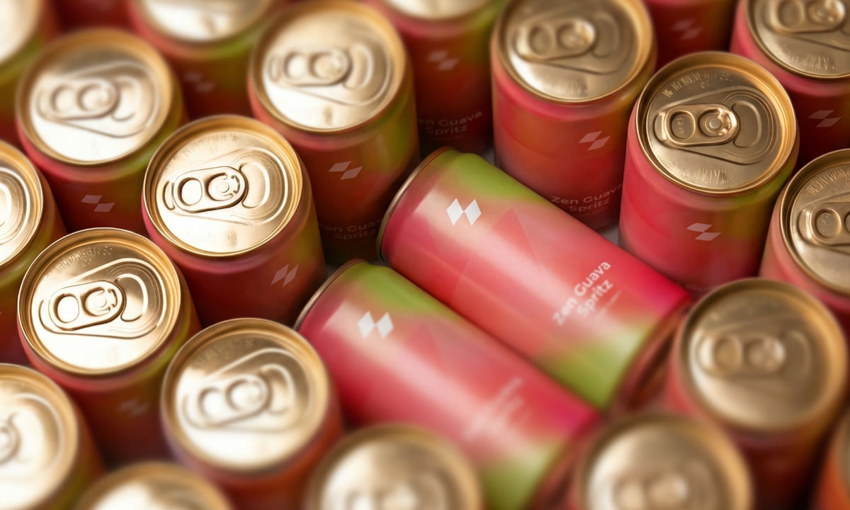 Close-up of multiple cans with gold tops and colorful bodies.