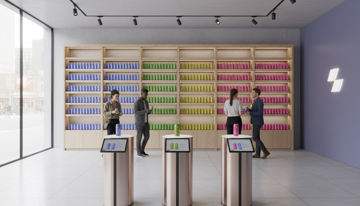 Modern store interior with shelves displaying colorful products and customers using digital tablets.