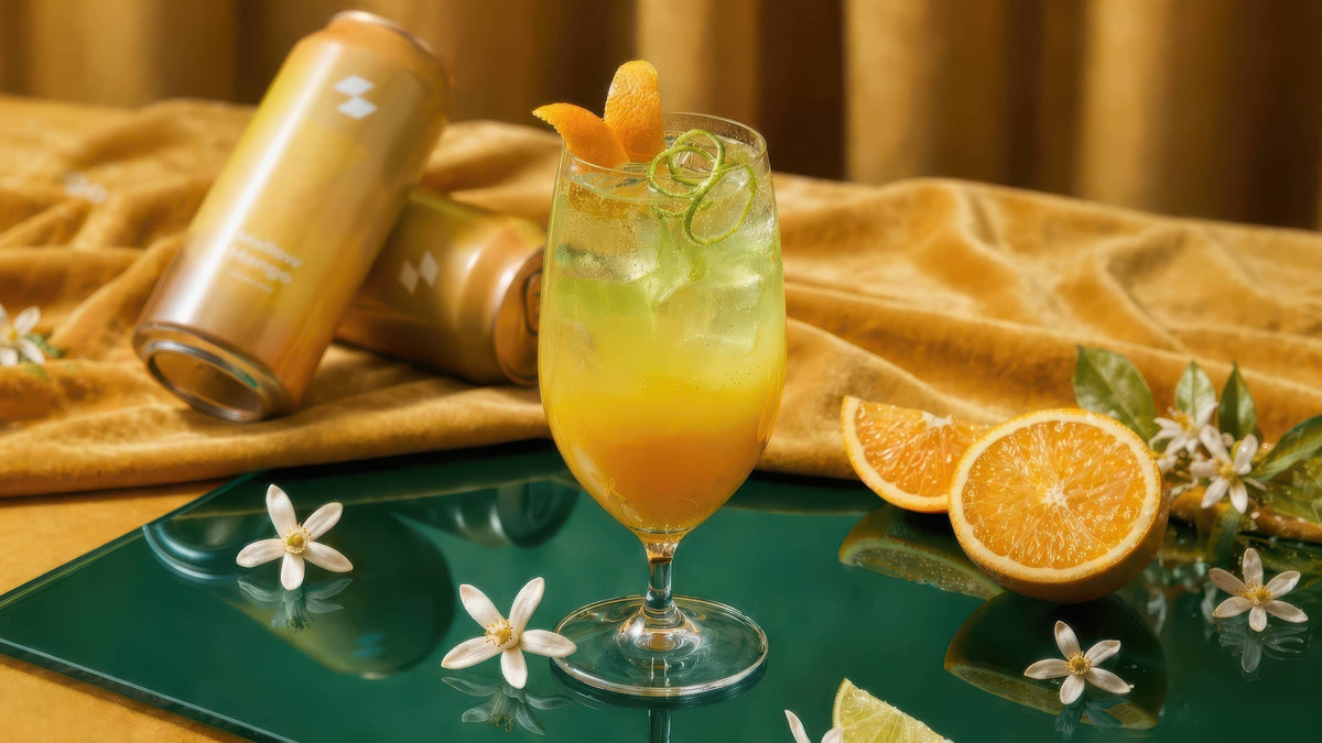 Citrus sparkling cocktail with orange slices and beverage cans