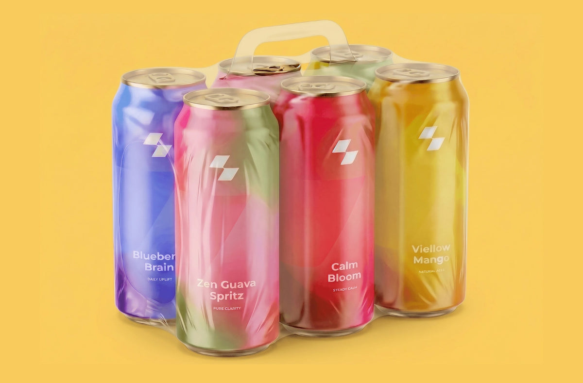 Six colorful cans of a beverage on a yellow background