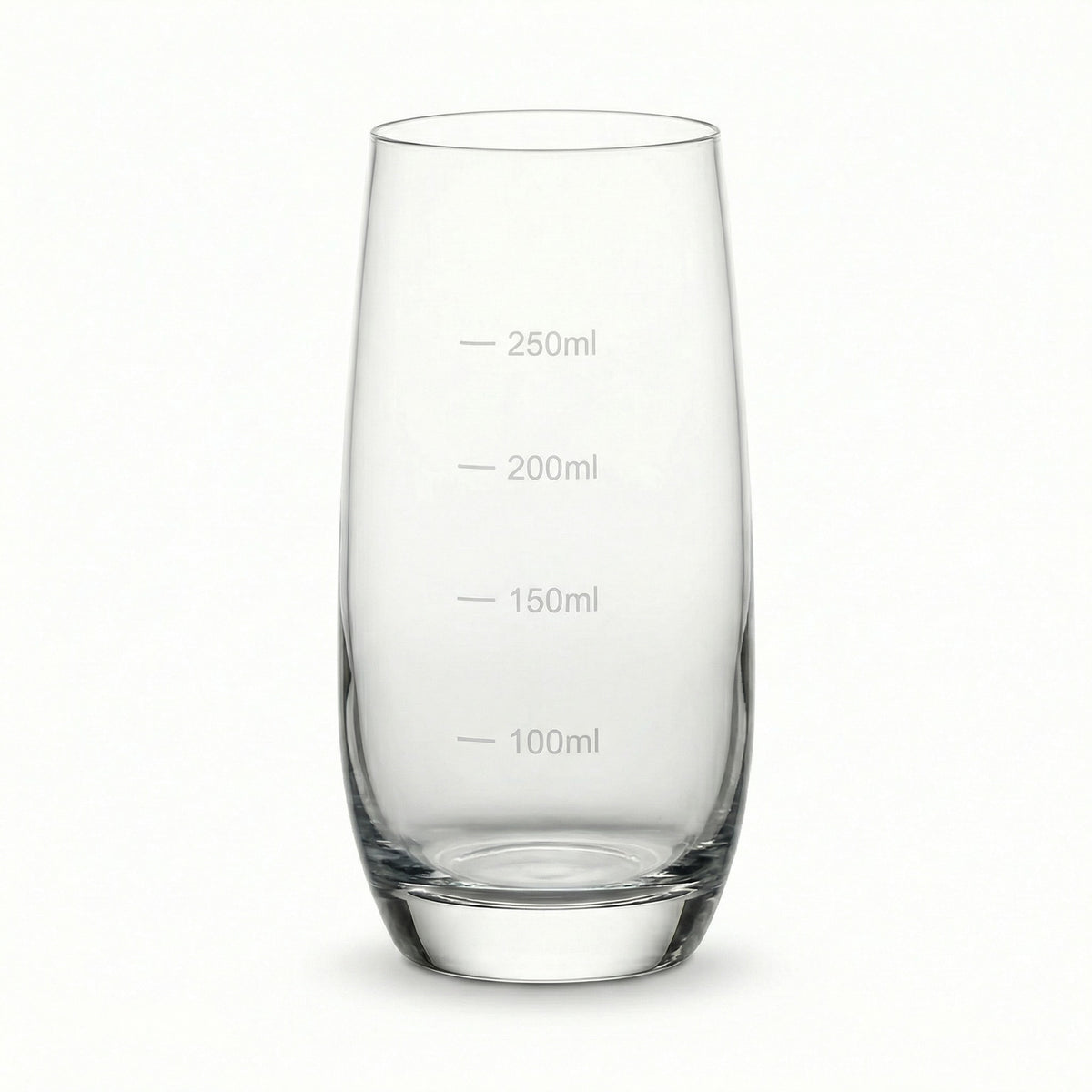 Clear glass tumbler with measurement markings on a white background