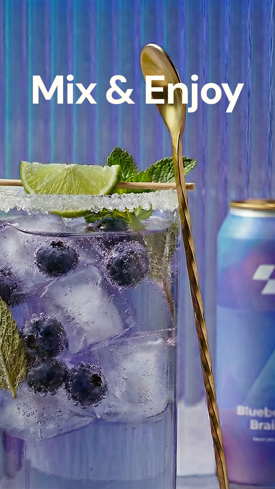 Glass of blueberry lemonade with ice, lime, and mint next to a can of blueberry lemonade on a blue background.