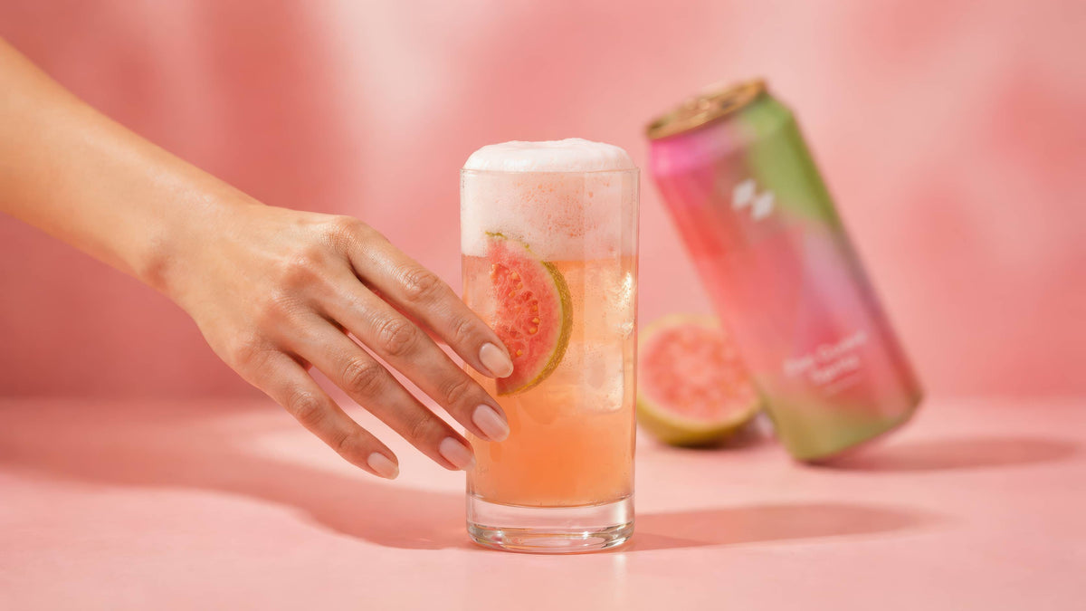 Hand holding pink guava sparkling cocktail with beverage can